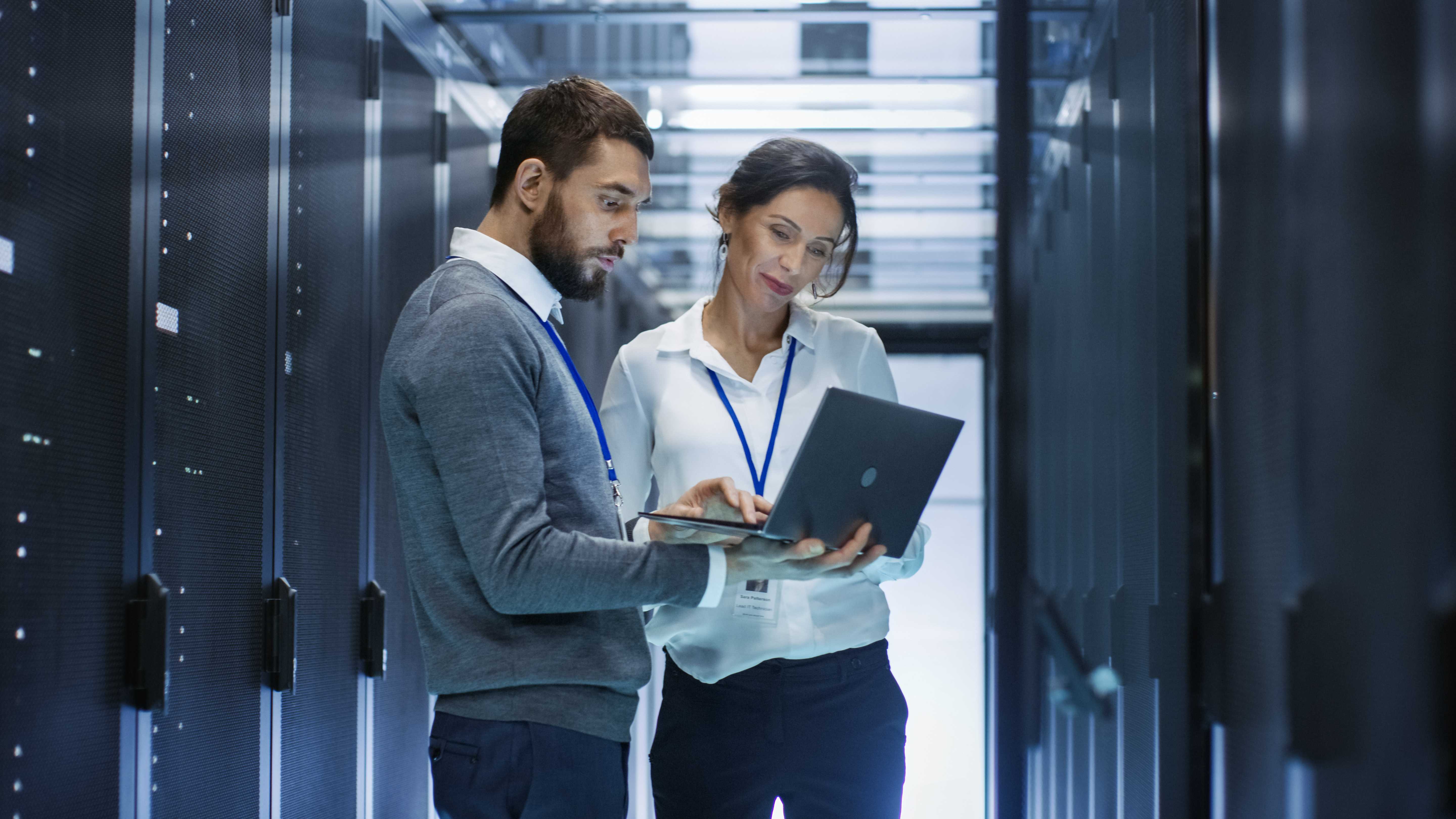 Technology workers in server room