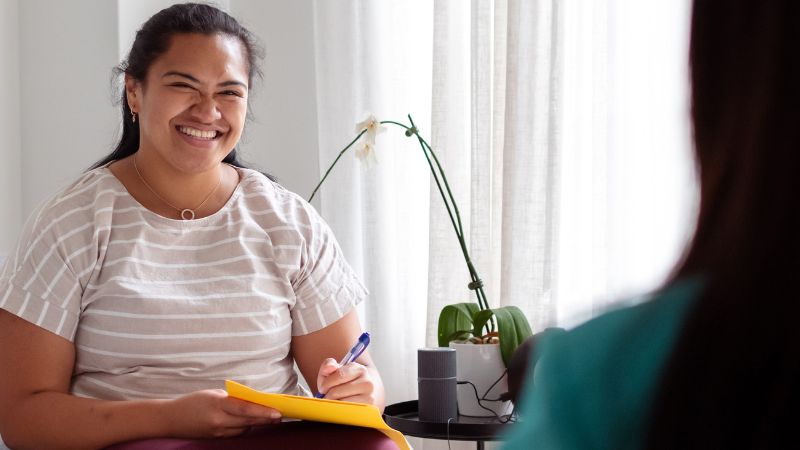 Health care worker interviewing patient