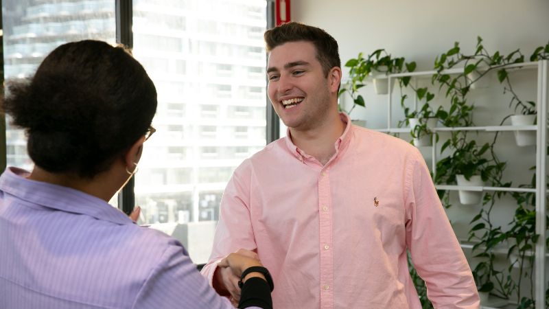 Graduate student and Interviewer shaking hands at interview