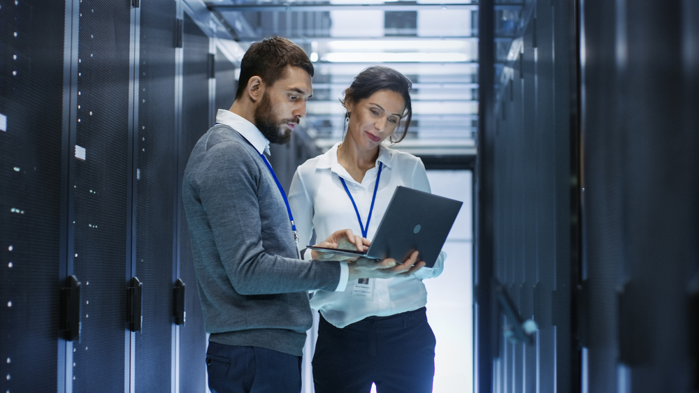 Two employees in server room